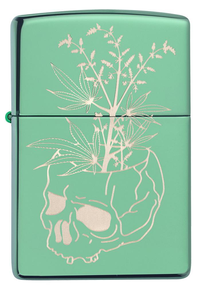Vue de face briquet Zippo vert brillant tête de mort servant de pot à un plant de chanvre